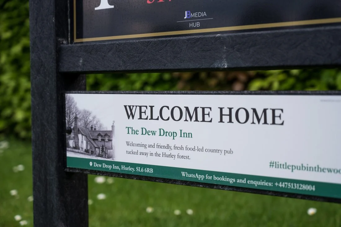 The Dew Drop Inn sponsor panel installed on a tee sign
