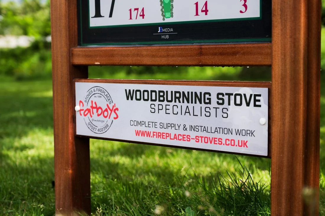 Fatboy’s Stoves & Fireplaces sponsor panel installed on a tee sign