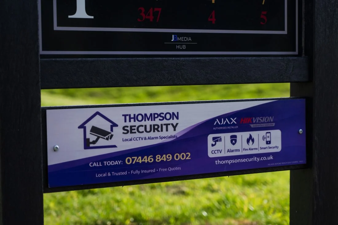 Thompson Security sponsor panel installed on a tee sign